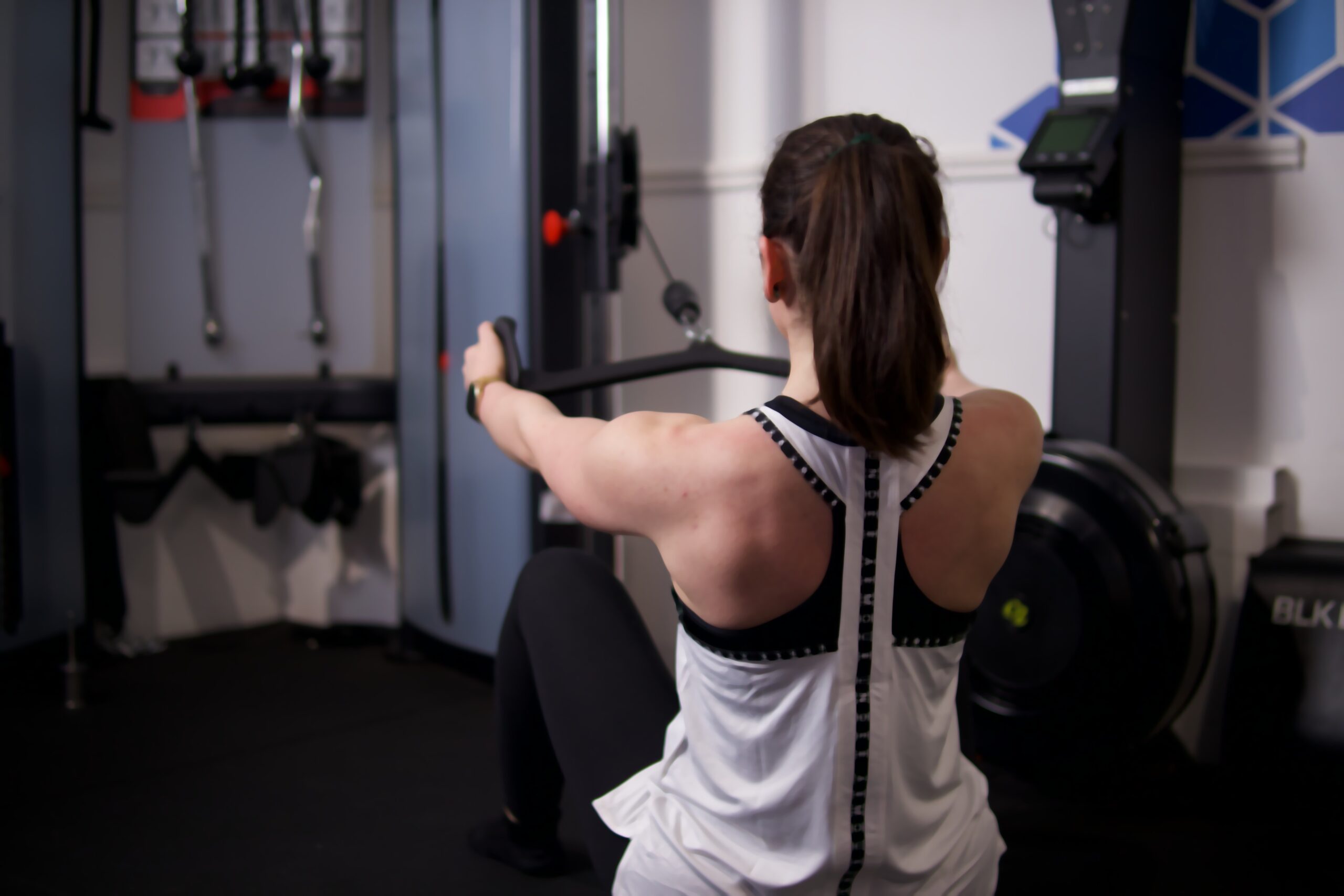 A woman training on a rower during a SixFour Fitness class